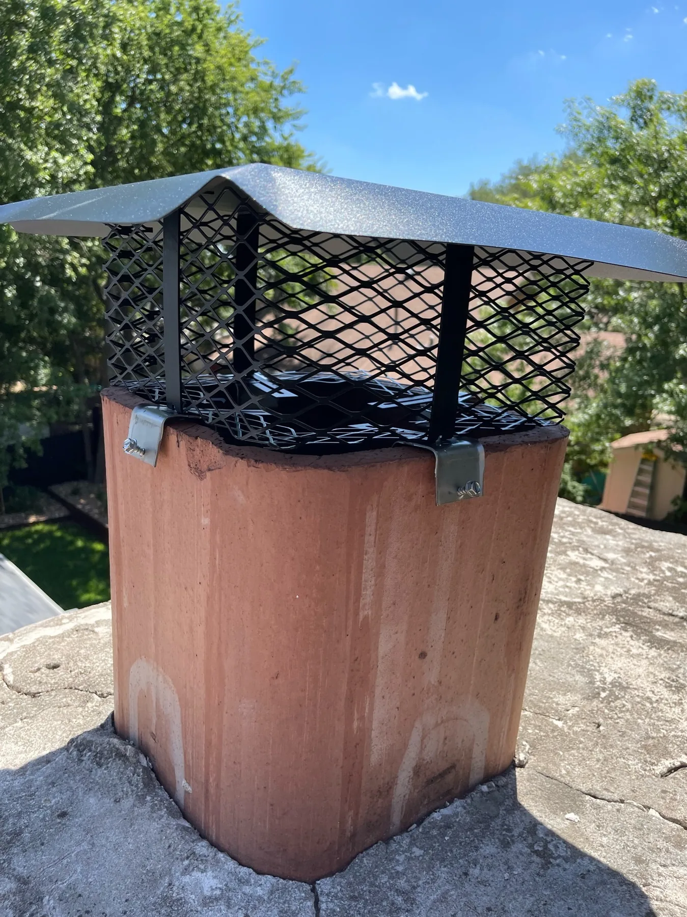 Damaged chimney cap with animal access concern